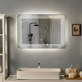A clean bathroom featuring a mirror above a sink, with neutral-colored walls and a bright, well-lit atmosphere.